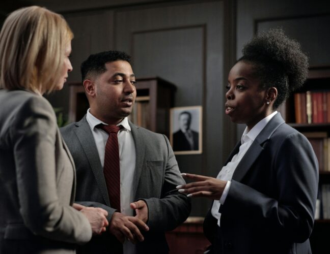 Diverse professionals engaged in strategic discussion in a law office setting.